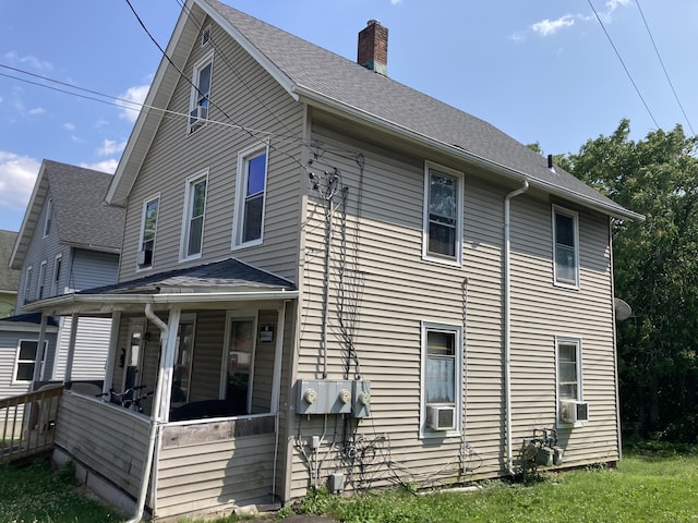 203 E Main St, Middletown, CT 06457 - view of side of home with a chimney, cooling unit, roof with shingles, and a porch