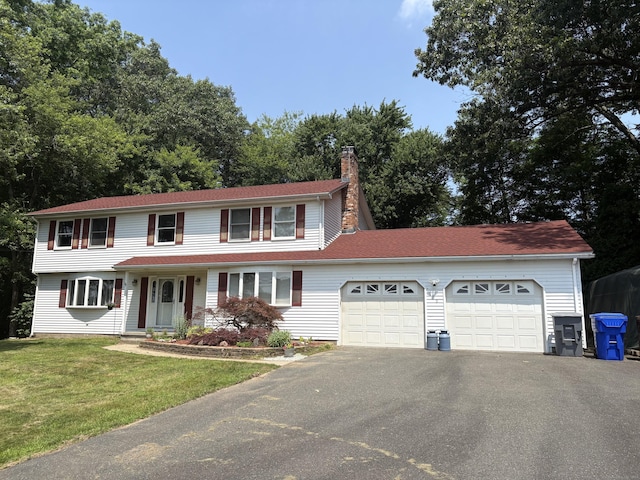 109 Middle Rd, Enfield, CT 06082 - view of front of home featuring a garage, asphalt driveway, a chimney, and a front lawn