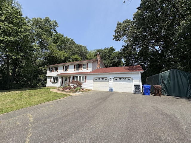 109 Middle Rd, Enfield, CT 06082 - view of front of property with a garage, a chimney, asphalt driveway, and a front yard