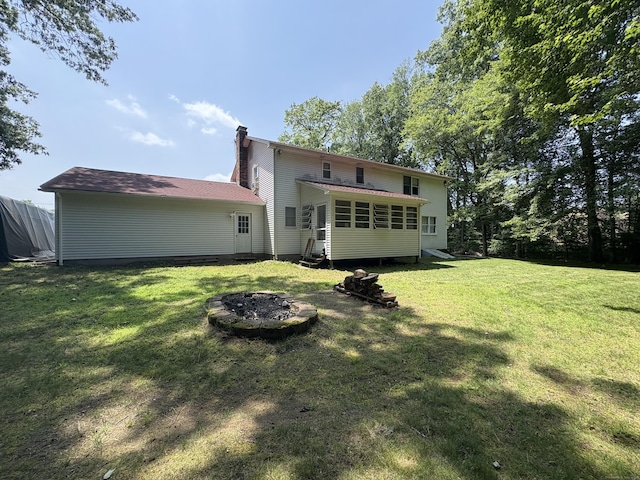 109 Middle Rd, Enfield, CT 06082 - rear view of property featuring entry steps, a chimney, a yard, and a fire pit