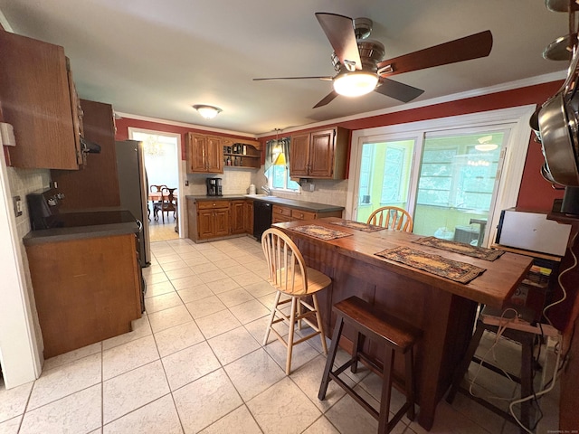 109 Middle Rd, Enfield, CT 06082 - kitchen with black dishwasher, tasteful backsplash, dark countertops, brown cabinetry, and ceiling fan