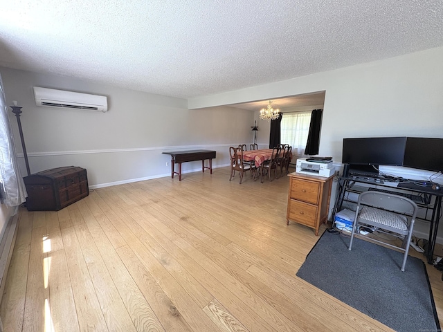 109 Middle Rd, Enfield, CT 06082 - office space featuring a chandelier, a wall mounted AC, a textured ceiling, and light wood-style flooring