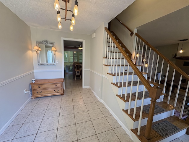 109 Middle Rd, Enfield, CT 06082 - stairs featuring tile patterned flooring, a textured ceiling, and ceiling fan