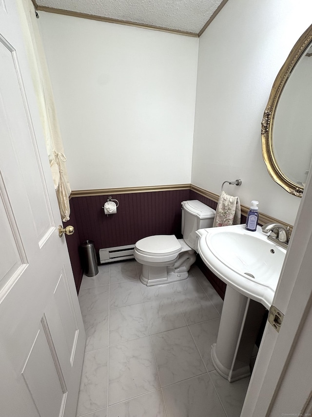 109 Middle Rd, Enfield, CT 06082 - bathroom featuring a baseboard heating unit, wainscoting, marble look tile flooring, crown molding, and wood walls