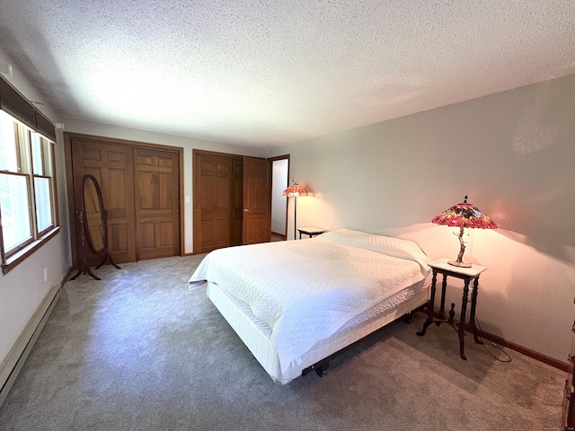 109 Middle Rd, Enfield, CT 06082 - bedroom featuring light colored carpet, baseboard heating, two closets, and a textured ceiling
