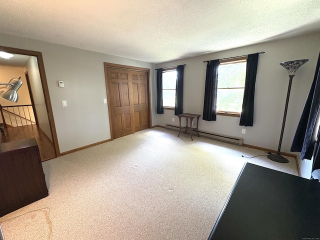 109 Middle Rd, Enfield, CT 06082 - unfurnished bedroom with baseboard heating, a textured ceiling, light colored carpet, and a closet