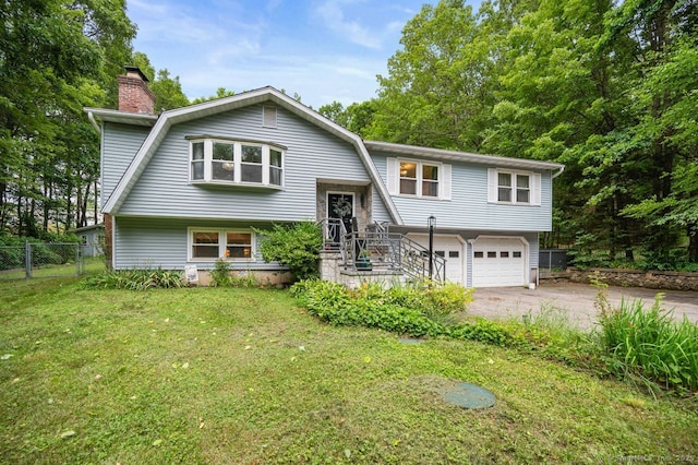 1996 Straits Tpke, Middlebury, CT 06762 - raised ranch featuring concrete driveway, an attached garage, a chimney, and a gambrel roof