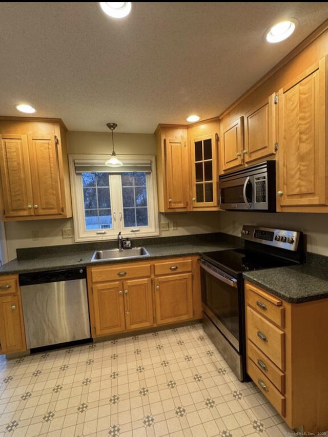126 Sunnydale Ave, Bristol, CT 06010 - kitchen featuring stainless steel appliances, dark countertops, recessed lighting, brown cabinets, and light floors
