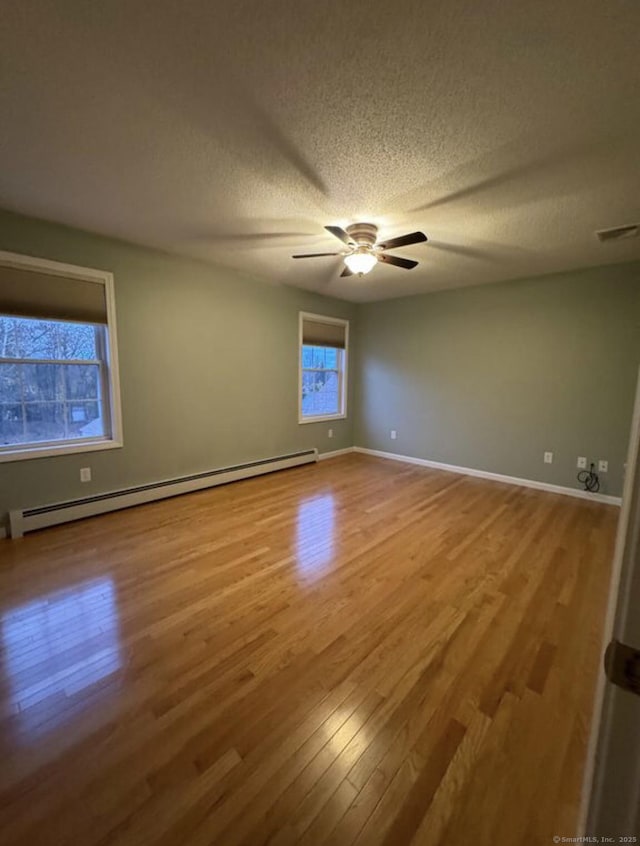 126 Sunnydale Ave, Bristol, CT 06010 - empty room with a baseboard radiator, wood finished floors, a textured ceiling, and ceiling fan