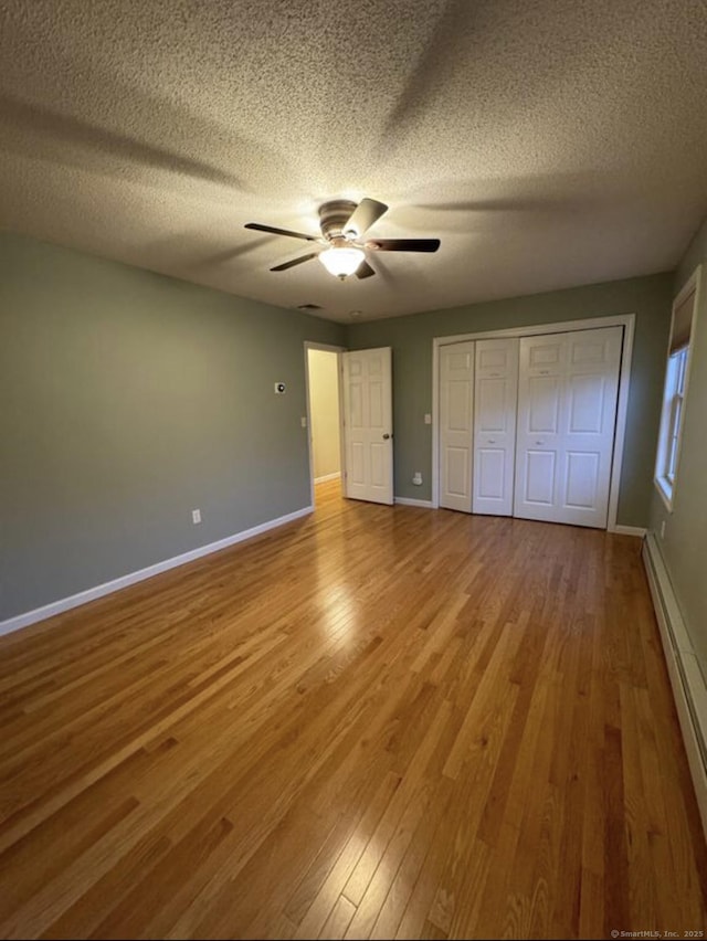 126 Sunnydale Ave, Bristol, CT 06010 - unfurnished bedroom featuring baseboard heating, wood finished floors, a textured ceiling, a closet, and ceiling fan