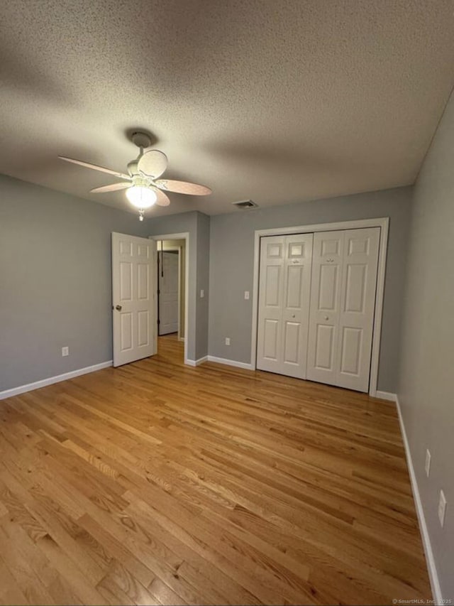 126 Sunnydale Ave, Bristol, CT 06010 - unfurnished bedroom featuring light wood finished floors, a textured ceiling, a closet, and ceiling fan