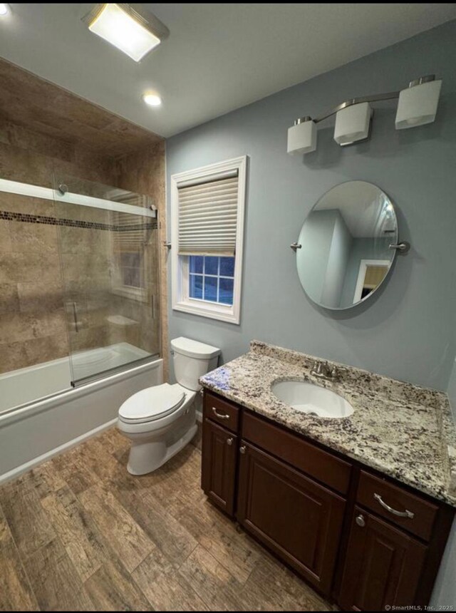 126 Sunnydale Ave, Bristol, CT 06010 - bathroom featuring vanity, enclosed tub / shower combo, wood finished floors, and recessed lighting