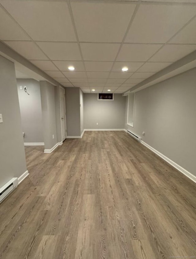 126 Sunnydale Ave, Bristol, CT 06010 - finished below grade area featuring wood finished floors, a drop ceiling, recessed lighting, and a baseboard heating unit