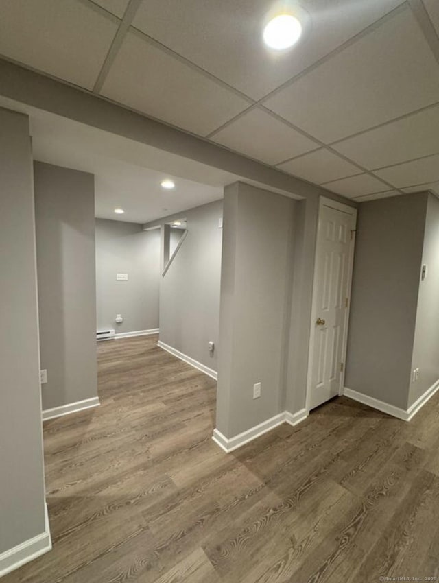 126 Sunnydale Ave, Bristol, CT 06010 - finished below grade area featuring wood finished floors, baseboard heating, recessed lighting, and a paneled ceiling