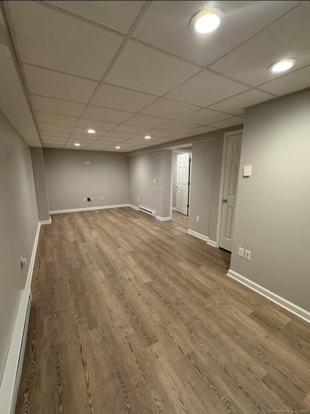 126 Sunnydale Ave, Bristol, CT 06010 - unfurnished room featuring wood finished floors, a baseboard heating unit, recessed lighting, a baseboard radiator, and a paneled ceiling