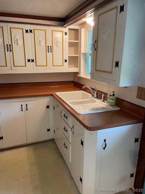 574 Cutlers Farm Rd, Monroe, CT 06468 - kitchen with dark countertops and cream cabinets
