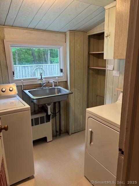 574 Cutlers Farm Rd, Monroe, CT 06468 - laundry area with washer and dryer, wood ceiling, cabinet space, wood walls, and radiator heating unit