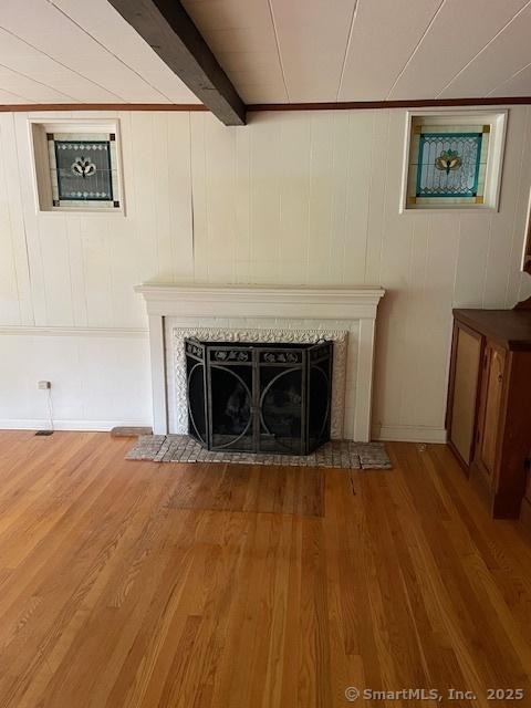 574 Cutlers Farm Rd, Monroe, CT 06468 - detailed view of a tile fireplace, wood finished floors, and beamed ceiling