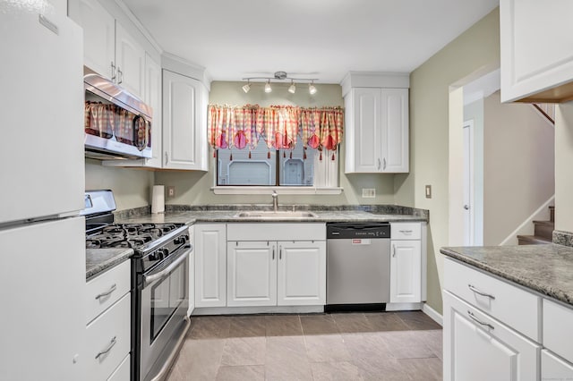 233 Derby Ave Unit 103, Derby, CT 06418 - kitchen with appliances with stainless steel finishes and white cabinetry
