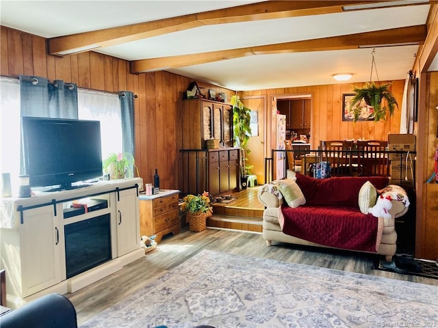 44 Cheyenne Rd, East Hartford, CT 06118 - living room featuring wooden walls, beamed ceiling, and light wood-type flooring