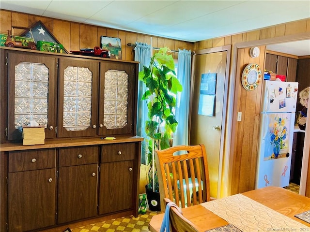 44 Cheyenne Rd, East Hartford, CT 06118 - dining space with wooden walls and tile patterned floors