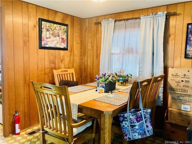 44 Cheyenne Rd, East Hartford, CT 06118 - dining room featuring wooden walls and tile patterned floors