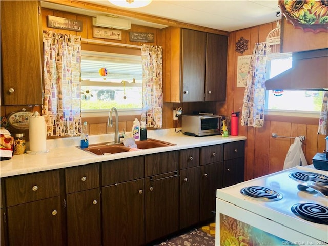 44 Cheyenne Rd, East Hartford, CT 06118 - kitchen with electric stove, light countertops, and dark brown cabinetry