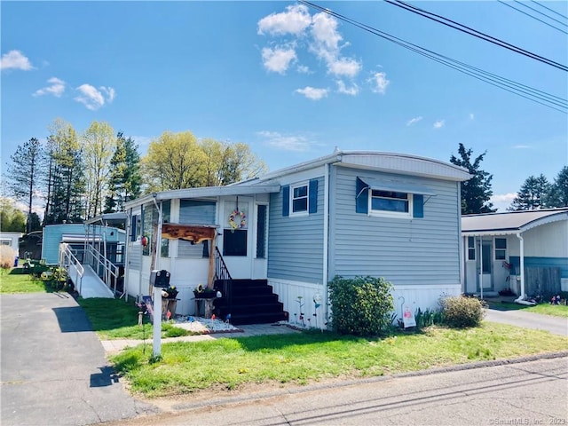 44 Cheyenne Rd, East Hartford, CT 06118 - manufactured / mobile home with entry steps and a front lawn