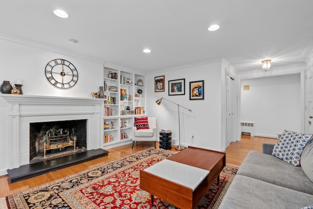 1981 Asylum Ave, West Hartford, CT 06117 - living room featuring radiator heating unit, ornamental molding, light wood-style flooring, recessed lighting, and built in shelves