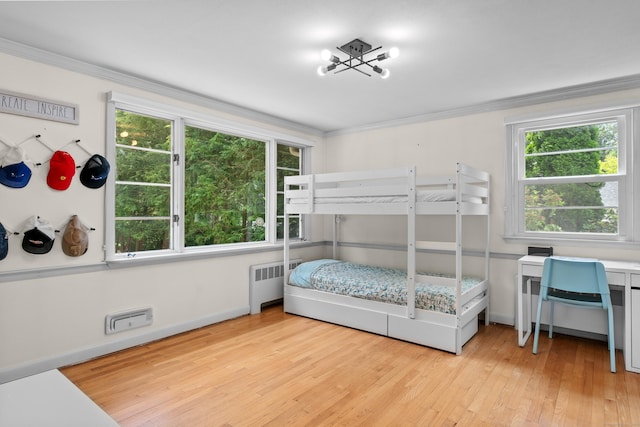1981 Asylum Ave, West Hartford, CT 06117 - bedroom featuring radiator heating unit, multiple windows, ornamental molding, and light wood-style flooring