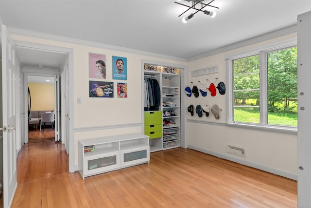1981 Asylum Ave, West Hartford, CT 06117 - bedroom featuring crown molding, light wood-style flooring, a closet, and a chandelier