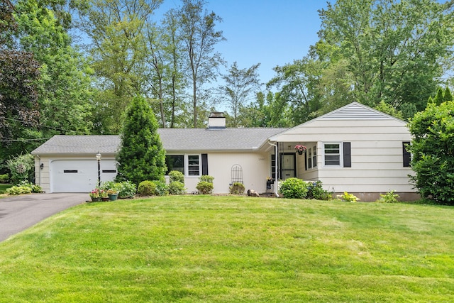 1981 Asylum Ave, West Hartford, CT 06117 - view of front of house with asphalt driveway, a chimney, an attached garage, and a front yard