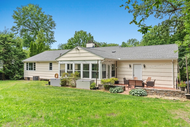 1981 Asylum Ave, West Hartford, CT 06117 - back of house with a chimney, a patio, a sunroom, a lawn, and a shingled roof