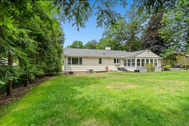 1981 Asylum Ave, West Hartford, CT 06117 - back of house featuring a chimney, a yard, and a sunroom