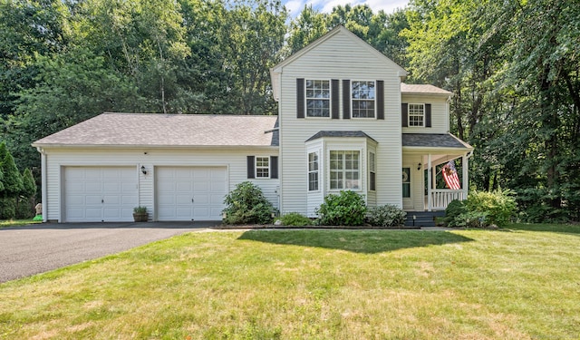 22 Quail Run, Bloomfield, CT 06002 - view of front facade with covered porch, asphalt driveway, a front yard, a garage, and a shingled roof