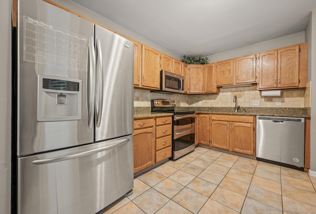 22 Quail Run, Bloomfield, CT 06002 - kitchen with stainless steel appliances, light tile patterned flooring, decorative backsplash, and dark stone counters