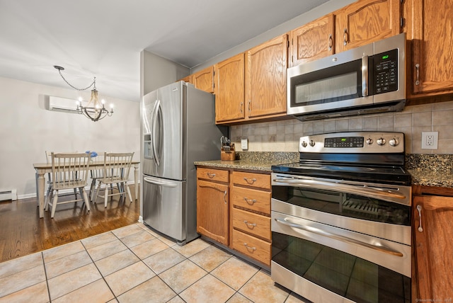 22 Quail Run, Bloomfield, CT 06002 - kitchen with stainless steel appliances, a chandelier, backsplash, and light tile patterned floors