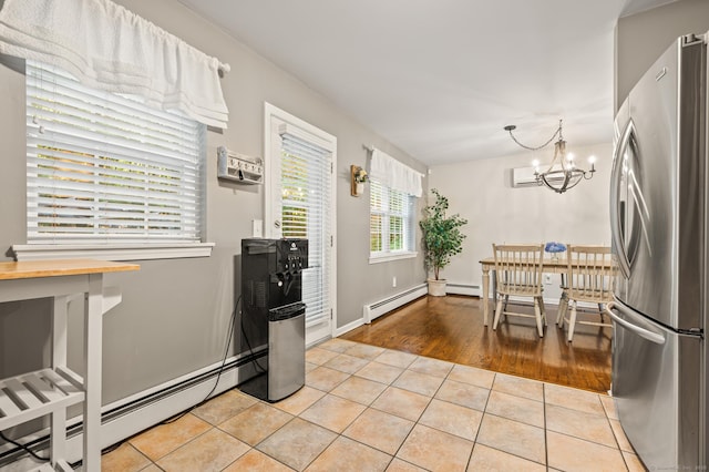 22 Quail Run, Bloomfield, CT 06002 - kitchen featuring freestanding refrigerator, light tile patterned floors, a chandelier, and a baseboard heating unit
