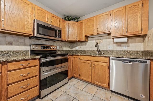 22 Quail Run, Bloomfield, CT 06002 - kitchen featuring appliances with stainless steel finishes, light tile patterned flooring, and tasteful backsplash