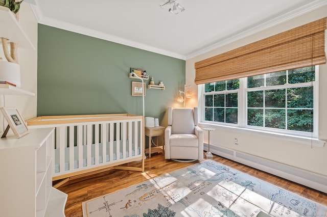22 Quail Run, Bloomfield, CT 06002 - bedroom with crown molding, baseboard heating, and wood finished floors