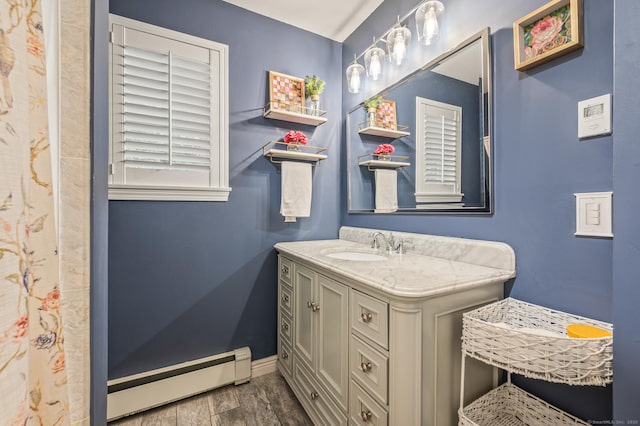 22 Quail Run, Bloomfield, CT 06002 - full bath with a baseboard radiator, vanity, and wood finished floors