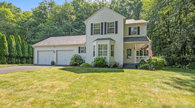 22 Quail Run, Bloomfield, CT 06002 - view of front facade featuring asphalt driveway, covered porch, a garage, and a front yard