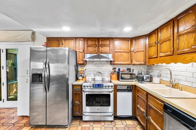 57 Notch Hill Rd, North Branford, CT 06471 - kitchen featuring stainless steel appliances, extractor fan, brown cabinets, light countertops, and decorative backsplash