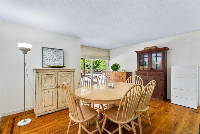 57 Notch Hill Rd, North Branford, CT 06471 - dining space with light wood finished floors and a textured ceiling