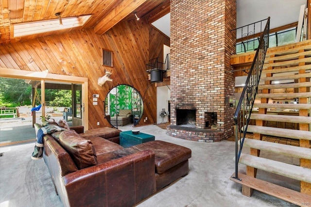 57 Notch Hill Rd, North Branford, CT 06471 - living room featuring wood walls, high vaulted ceiling, a brick fireplace, stairway, and carpet