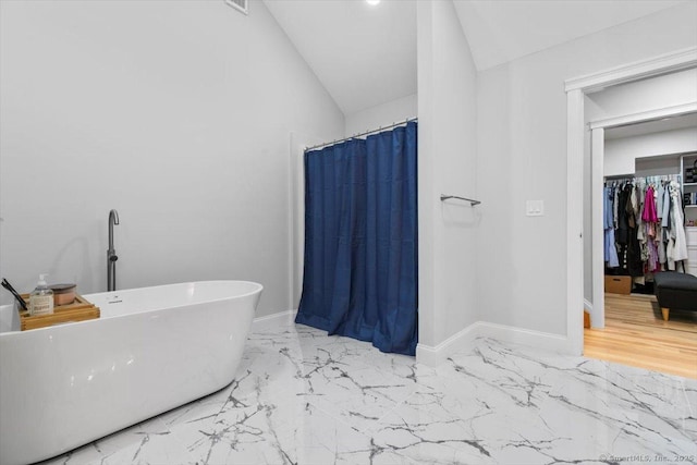 57 Notch Hill Rd, North Branford, CT 06471 - bathroom featuring marble finish flooring, lofted ceiling, a shower with shower curtain, and a soaking tub