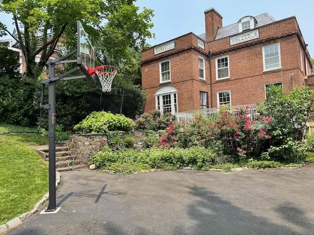 192 Bishop St, New Haven, CT 06511 - view of home's exterior featuring brick siding, a chimney, and a lawn