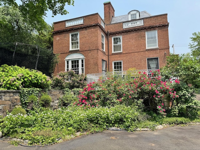 192 Bishop St, New Haven, CT 06511 - view of front facade with brick siding, mansard roof, and a chimney