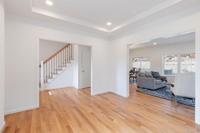 807 Pucker St, Coventry, CT 06238 - living room featuring light wood-style flooring, stairs, recessed lighting, and a tray ceiling