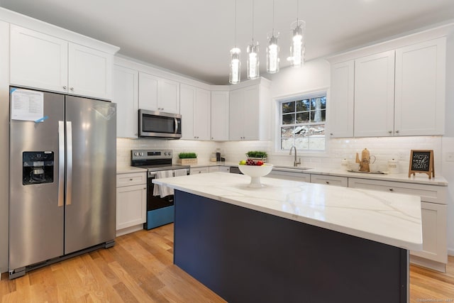 807 Pucker St, Coventry, CT 06238 - kitchen featuring appliances with stainless steel finishes, backsplash, white cabinetry, and light wood-style floors
